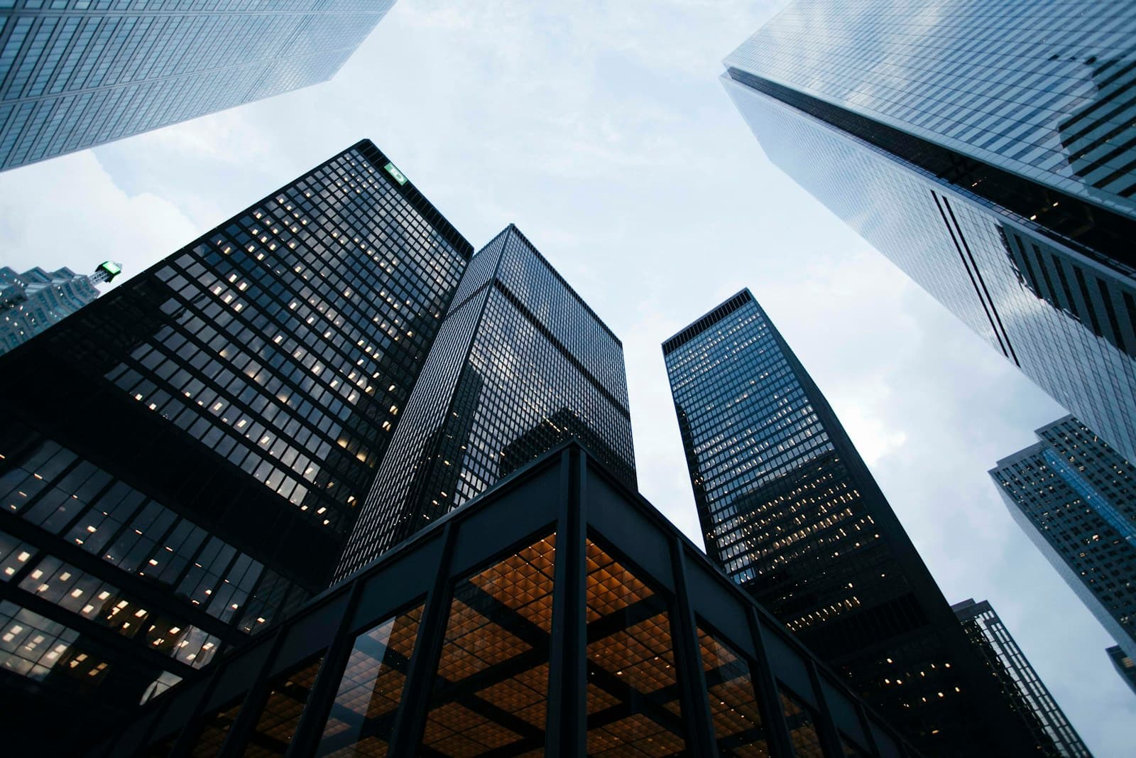 Looking up between the glass towers of a financial district